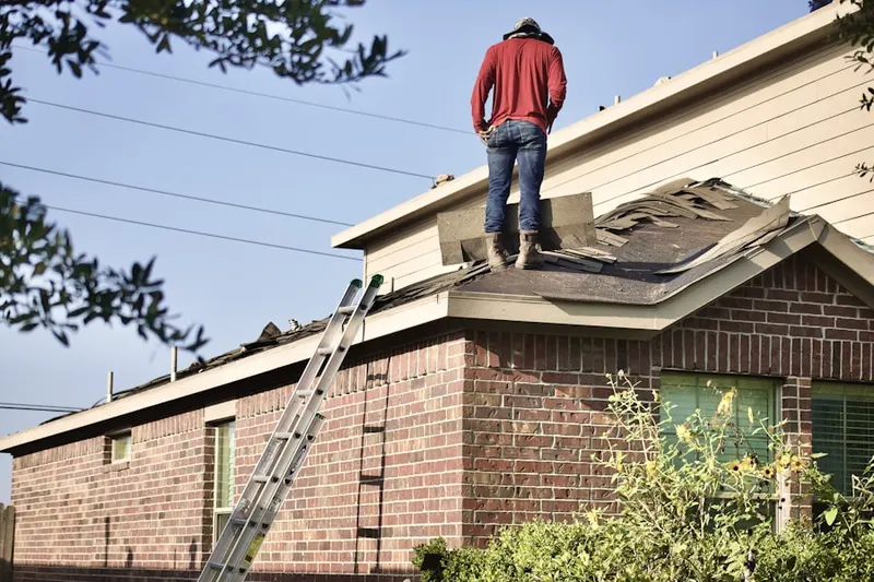 Professional roofer working on a residential roof in Founders Village